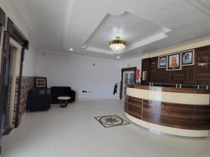 a lobby with a reception desk in a building at Admiralty Hotel in Lekki