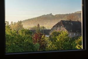 a view from a window of a house and trees at Apartament w Karkonoszach in Piechowice