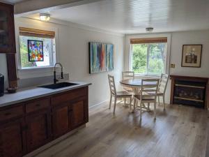 a kitchen and dining room with a table and chairs at Surfmen's Cottage - Historic Coast Guard property in Point Arena