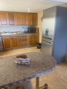 a kitchen with a granite counter top and a refrigerator at résidence les meridiennes tiguert in Agadir