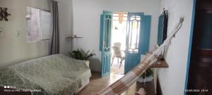 a hallway with a blue door and a stair case at Casas 1 de Isaac in Maragogi