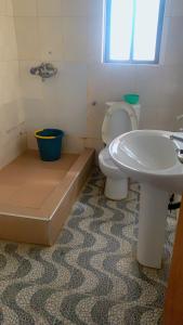 a bathroom with a toilet and a sink at Blue Moon Hotel Victoria Island in Lagos