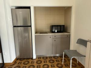 a kitchen with a stainless steel refrigerator and a microwave at Rossini aptm in Sassoferrato