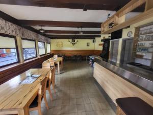 a dining room with wooden tables and chairs in a restaurant at Rooms MARETČ in Bohinj