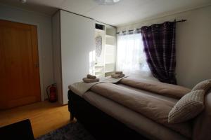 a room with a bed with two teddy bears on it at Cozy room in a house with a garden on the island of Askøy, near Bergen in Askøy