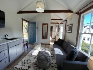 a living room with a couch and a kitchen at Boathouse Cottage (Historic Coast Guard property) in Point Arena
