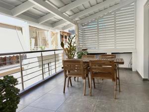 a dining room with a table and chairs at Central, spacious and bright 2-bedroom apartment By Estio Comfort Living in Heraklio