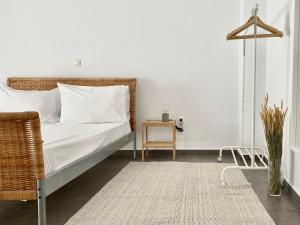 a white bedroom with a bed and a table at Central, spacious and bright 2-bedroom apartment By Estio Comfort Living in Heraklio