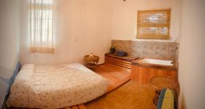 a bedroom with a bed and a bath tub at Casa Qi in Villa Giardino +13 photos
