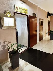 a lobby with a door and a potted plant at Hotel Lubavia in Lubawka