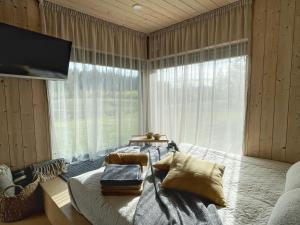 a bedroom with a bed and a large window at MySikaSpot Black in Sika