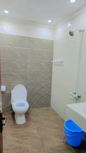 a bathroom with a toilet and a sink at Clifton Lodge Boutique Hotel in Karachi