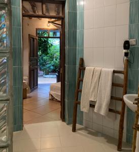 a bathroom with a sink and a bed in a room at PASA LODGE ZANZIBAR in Nungwi