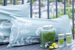 a table with a pillow and a jar of green liquid at Großzügige Panorama-Suite „Grüne Oase“ in Leonberg