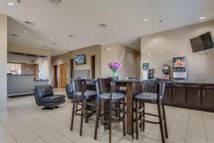Un vestíbulo con un bar con sillas y un mostrador. en Executive Inn & Suites Cushing, en Cushing