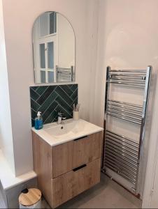 a bathroom with a sink and a mirror at Victorian Cottage - The Beach Walmer in Walmer