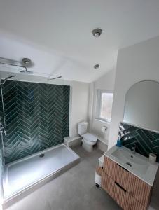 a bathroom with a tub and a sink and a toilet at Victorian Cottage - The Beach Walmer in Walmer