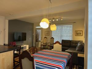 a living room with a couch and a table at Le 2316 in Saint-Hyacinthe