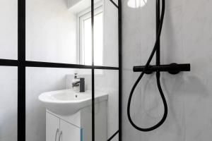 a bathroom with a shower and a sink at Redworth Lodge in Billingham +19 photos