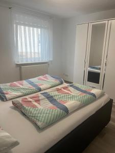 a bedroom with two beds and a window at 4 Zimmer Ferienwohnung am Bodensee in Friedrichshafen
