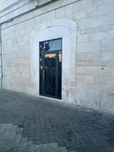 a door in the side of a brick building at Suites Elifani in Trani