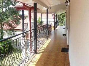 a balcony with a fence and tables on it at VILLA BIAŁA in Okuninka