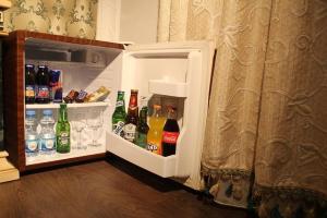 an open refrigerator filled with bottles and drinks at Hotel Adria in Pristina