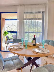 a dining room table with a bottle of wine on it at Apartamento Familiar in Villajoyosa