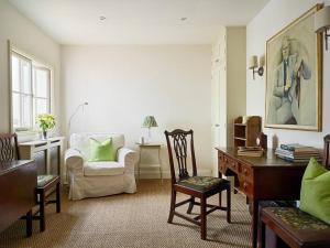 uma sala de estar com uma secretária e uma cadeira em Northfield End Cottage em Henley on Thames