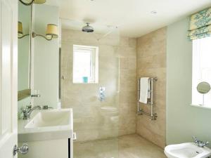 a bathroom with a sink and a toilet and a shower at Northfield End Cottage in Henley on Thames +17 photos