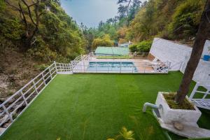 an aerial view of a house with a green lawn at Little Heaven - Cabin 2 in Rājpur