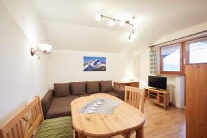 a living room with a couch and a table at Landhaus Lina in Wallgau