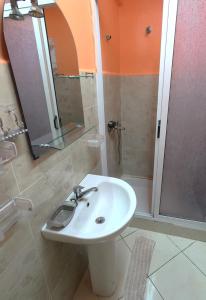 a bathroom with a sink and a shower at Cosy apartement close to the AIRPORT in Tangier