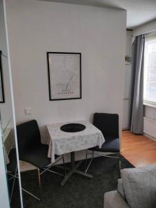 a living room with a table and two chairs at Railway&bus station studio in Oulu