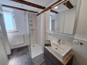 a white bathroom with a sink and a shower at Ferienhaus Altstadt in Bamberg +9 photos