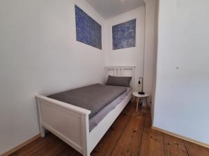 a bedroom with a bed in a white room at Ferienhaus Altstadt in Bamberg
