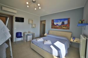 a bedroom with a bed and a desk and a bed at A casa di Sofia in Porto Cesareo