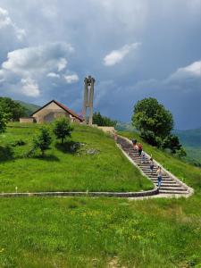 a group of people standing on steps on a hill at Landhaus Kate in Lusnić