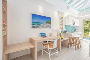a home office with a desk and a laptop on it at CocoonHuts Residences Martinique in Le Lamentin