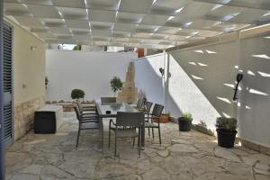 a patio with a table and chairs on a patio at A casa di Sofia in Porto Cesareo
