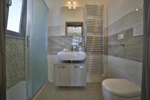 a bathroom with a sink and a toilet at A casa di Sofia in Porto Cesareo +70 photos