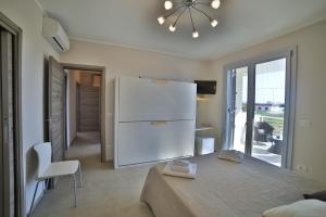a kitchen with a white refrigerator in a room at A casa di Sofia in Porto Cesareo