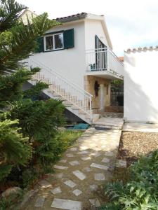 a house with a staircase and a walkway at Pension Oaza in Hvar