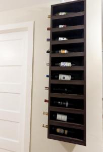 a wine rack in a wall with wine bottles at REI Condotel Arezzo place Davao in Davao City