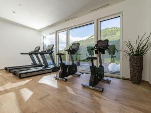 a gym with treadmills and a row of exercise bikes at Sun Valley - Wildschönau in Auffach