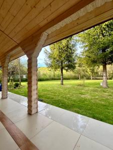 an open porch with a view of a park at Siedlisko Nad Potokiem in Hołuczków