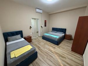 a room with two beds in a room at Hanna & Solei Hotel in Berat