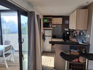 a small kitchen with a table and a balcony at Chalet contemporain in Carnac