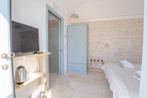 Postel nebo postele na pokoji v ubytování Trullo Dimora Podere Papilio