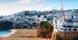 a view of a beach with white buildings at Casa T'Isabel - Fisherman's Beach - 2 bedrooms in Albufeira